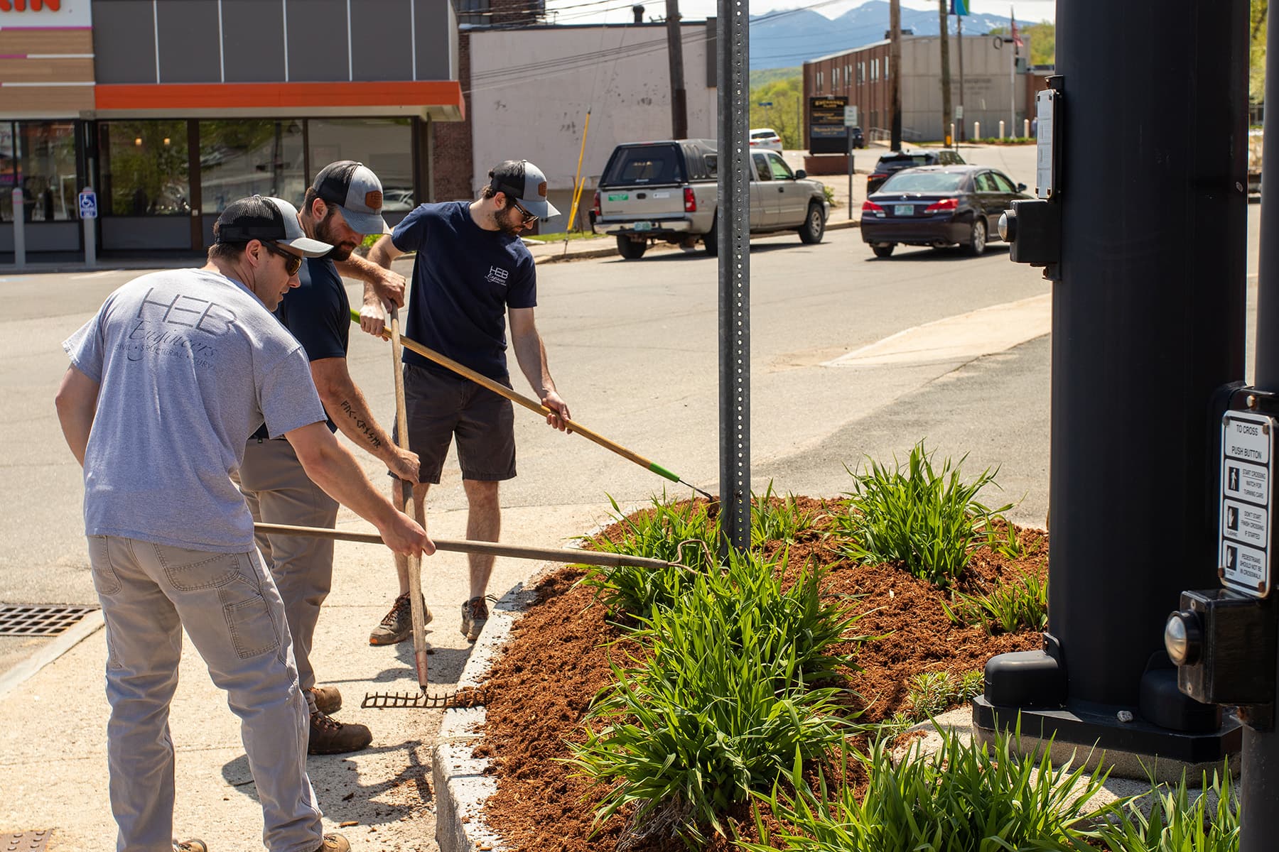 HEB staff raking mulch